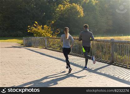 fitness, sport, people and jogging concept - couple running outdoors