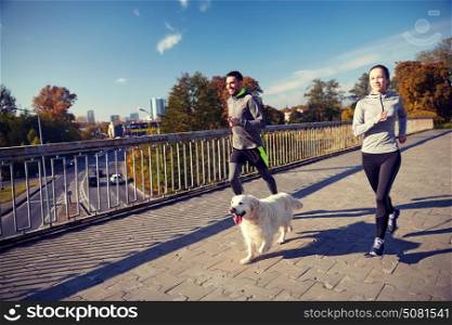 fitness, sport, people and jogging concept - happy couple with dog running outdoors. happy couple with dog running outdoors