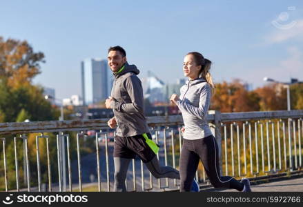 fitness, sport, people and lifestyle concept - happy couple running outdoors