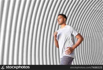 fitness, sport, people and lifestyle concept - sporty young man running in tunnel. sporty young man running in tunnel
