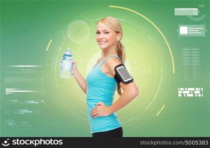 fitness, sport, people and technology concept - happy young woman running with earphones, smartphone and water bottle and listening to music over green background. woman with earphones and smartphone doing sports