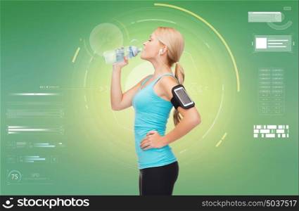 fitness, sport, people and technology concept - happy young woman running with earphones, smartphone and water bottle and listening to music over green background. woman training drinking water from bottle