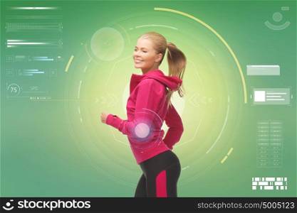 fitness, sport, people and technology concept - smiling young woman running over green background. smiling young woman running over green