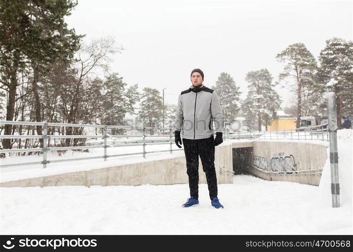 fitness, sport, people, exercising and healthy lifestyle concept - young man in winter outdoors