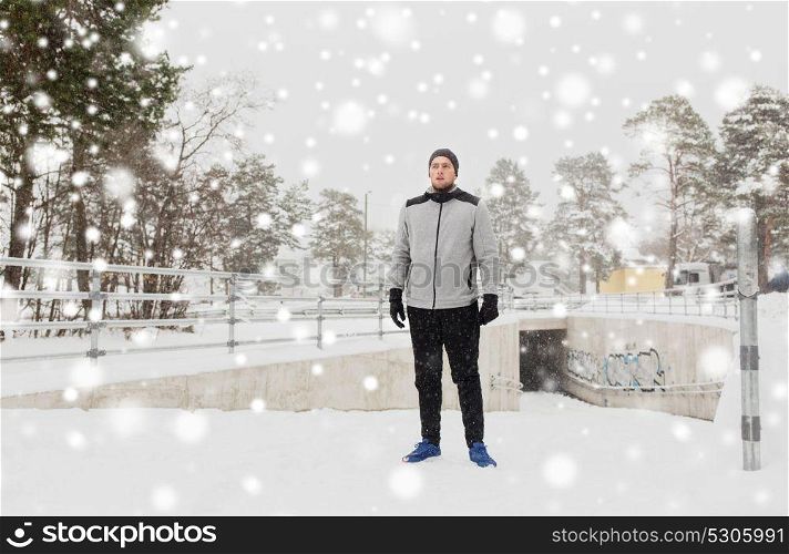 fitness, sport, people, exercising and healthy lifestyle concept - young man in winter outdoors. sports man in winter outdoors