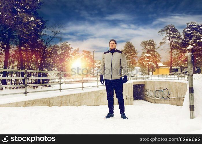 fitness, sport, people, exercising and healthy lifestyle concept - young man in winter outdoors. sports man in winter outdoors