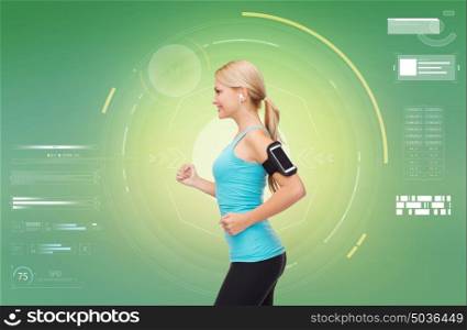 fitness, sport, people, exercising and technology concept - happy young woman running with earphones and smartphone and listening to music over green background. woman with earphones and smartphone doing sports