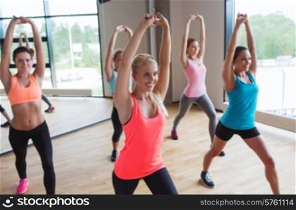 fitness, sport, people, teamwork and lifestyle concept - group of women working out in gym