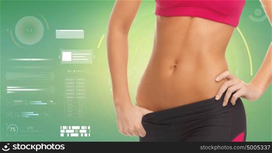 fitness, sport, power, technology and people concept - close up of sporty woman abdomen over green background. close up of sporty woman abdomen over green