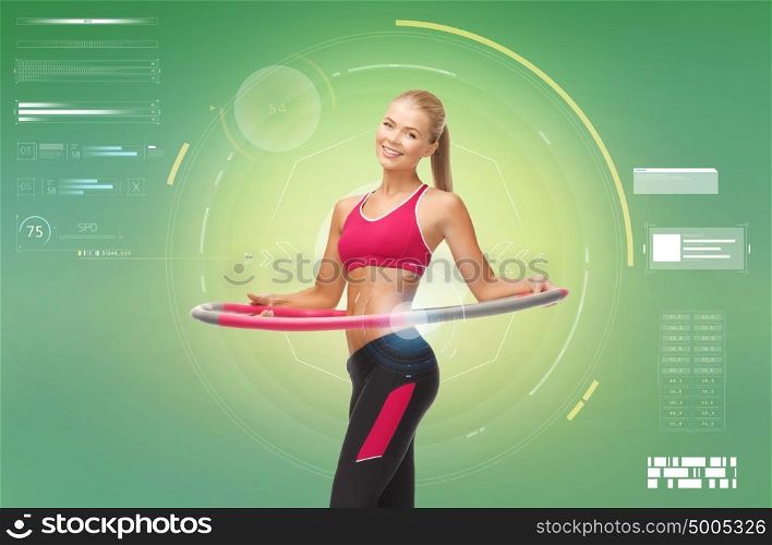 fitness, sport, power, technology and people concept - young sporty woman with hula hoop over green background. young sporty woman with hula hoop