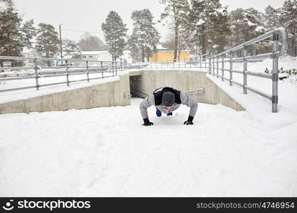 fitness, sport, training and lifestyle concept - couple doing push-ups outdoors