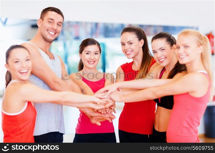 fitness, sport, training and lifestyle concept - group of happy people in the gym celebrating victory
