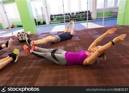 fitness, sport, training and lifestyle concept - group of people exercising in gym. group of people exercising in gym