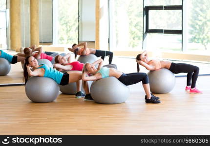 fitness, sport, training and lifestyle concept - group of smiling women with exercise balls in gym