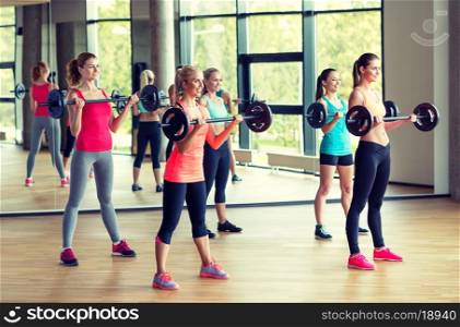 fitness, sport, training and lifestyle concept - group of women with barbells in gym