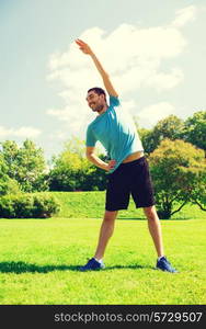 fitness, sport, training and lifestyle concept - smiling man stretching hand outdoors