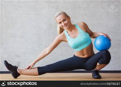 fitness, sport, training and people concept - smiling woman with exercise ball in gym