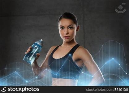 fitness, sport, training, drink and lifestyle concept - woman drinking water from bottle in gym. woman drinking water from bottle in gym