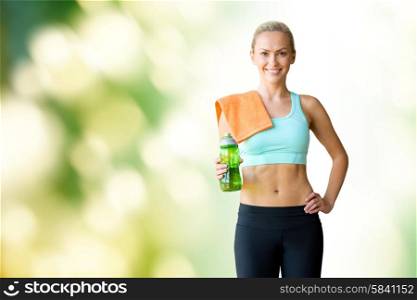 fitness, sport, training, drink and lifestyle concept - woman with bottle of water and towel over green natural background