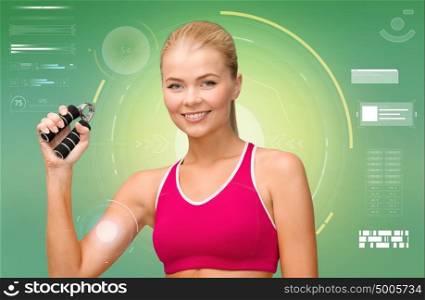fitness, sport, training, exercising and people concept - smiling woman doing exercises with expander over green background. sporty woman with expander over green background