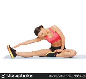 fitness, sport, training, gym and lifestyle concept - beautiful sporty woman doing exercise on the floor