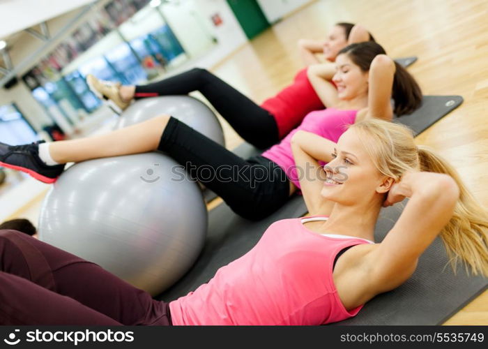 fitness, sport, training, gym and lifestyle concept - group of smiling people working out in pilates class