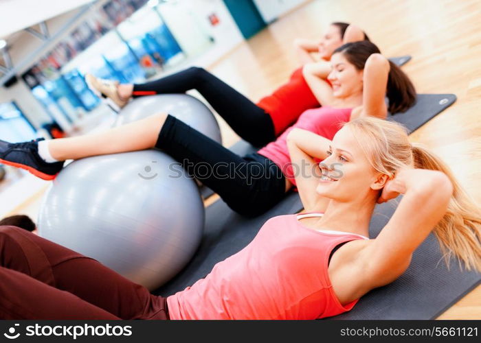 fitness, sport, training, gym and lifestyle concept - group of smiling people working out in pilates class