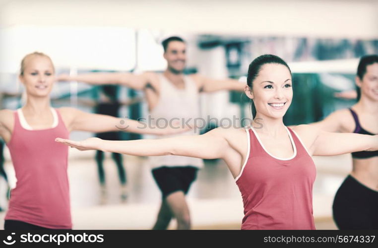 fitness, sport, training, gym and lifestyle concept - group of smiling people exercising in the gym