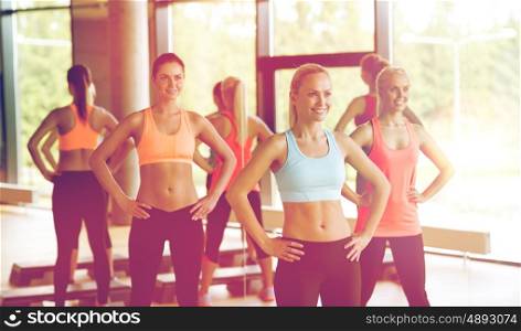 fitness, sport, training, gym and lifestyle concept - group of women working out in gym. group of women working out in gym