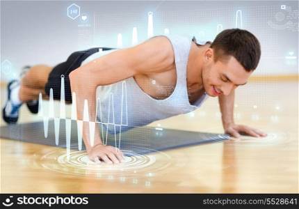 fitness, sport, training, gym and lifestyle concept - smiling man doing push-ups in the gym