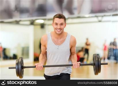 fitness, sport, training, gym and lifestyle concept - smiling man with barbell in gym