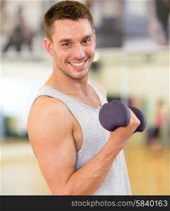 fitness, sport, training, gym and lifestyle concept - smiling man with dumbbell in gym
