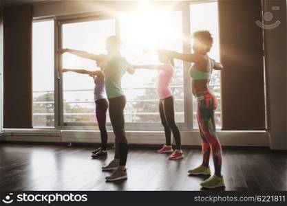 fitness, sport, training, gym and martial arts concept - group of happy women working out and fighting in gym