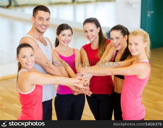 fitness, sport, training, gym, success and lifestyle concept - group of happy people in the gym celebrating victory