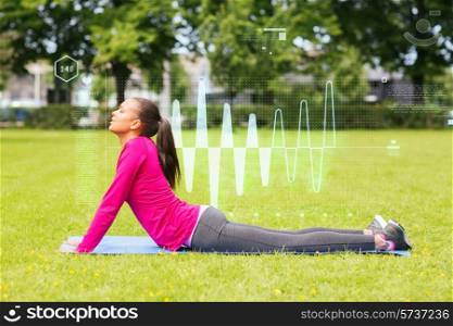 fitness, sport, training, park and lifestyle concept - smiling woman stretching back on mat outdoors