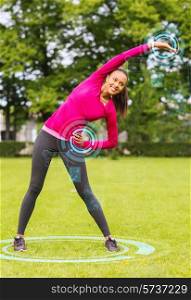 fitness, sport, training, park and lifestyle concept - smiling woman stretching back outdoors