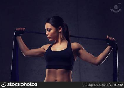 fitness, sport, training, people and lifestyle concept - woman doing exercises with expander in gym. woman with expander exercising in gym