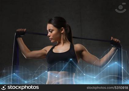 fitness, sport, training, people and lifestyle concept - woman doing exercises with expander in gym. woman with expander exercising in gym