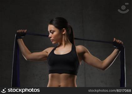 fitness, sport, training, people and lifestyle concept - woman doing exercises with expander in gym