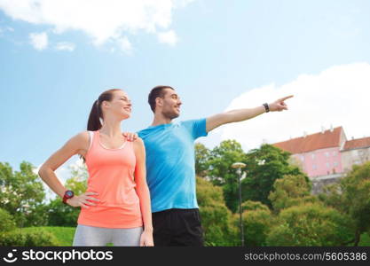 fitness, sport, training, technology and lifestyle concept - two smiling people outdoors