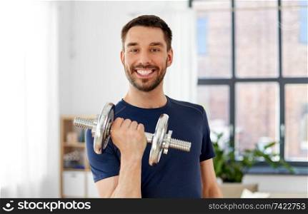 fitness, sport, weightlifting and bodybuilding concept - man exercising with dumbbell at home. man exercising with dumbbell at home