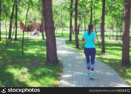 Fitness sporty woman jogger running at outdoors jogging track in park