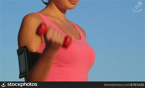 Fitness sporty woman lifting dumbbell weight training outside