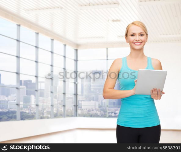 fitness, technology, people and sport concept - smiling woman with tablet pc computer over gym or home background