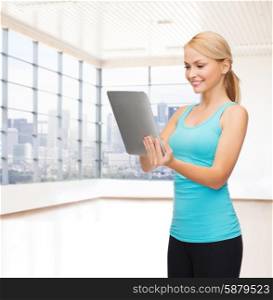 fitness, technology, people and sport concept - smiling woman with tablet pc computer over gym or home background