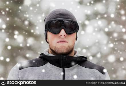 fitness, winter sport, people and healthy lifestyle concept - young man in ski goggles outdoors. sports man with ski goggles in winter outdoors