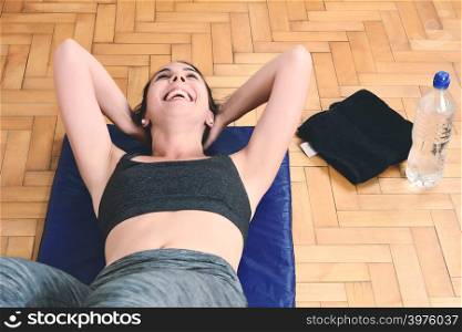 Fitness woman doing crunches at gym. Sport concept. Indoors