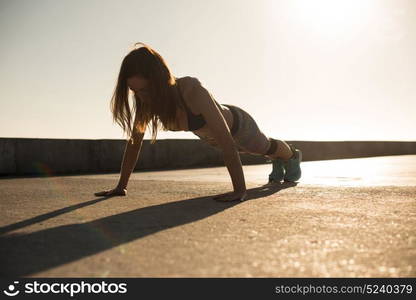 Fitness woman doing exercices on summer sunset