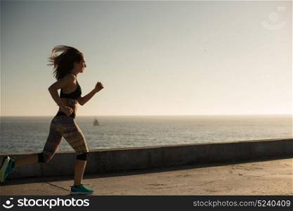 Fitness woman doing exercices on summer sunset