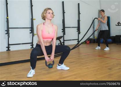 fitness woman doing exercising with kettle bell
